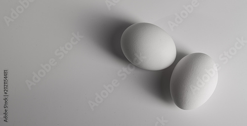 Canvas-taulu Two white eggs rest on a minimal surface, symbolizing purity and protein for a h