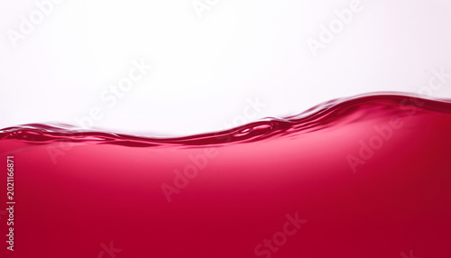 Close up texture of water waves in Red Burgundy color on a white background.