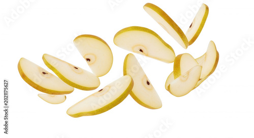 Sliced yellow pear pieces floating in mid-air against a solid black background, showing fresh fruit texture and seeds in a dynamic composition