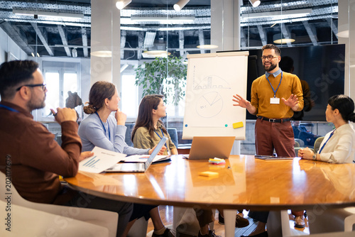 Obraz na plátně Business professional presenting data and strategy to diverse team in modern off