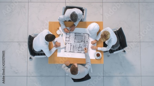 Team reviewing architectural plans overhead