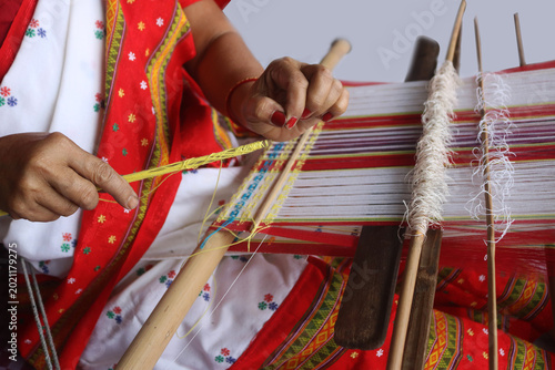 Bild auf Leinwand Loin loom weaver in India working in her loom.