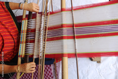 Loin loom weaver in India working in her loom.