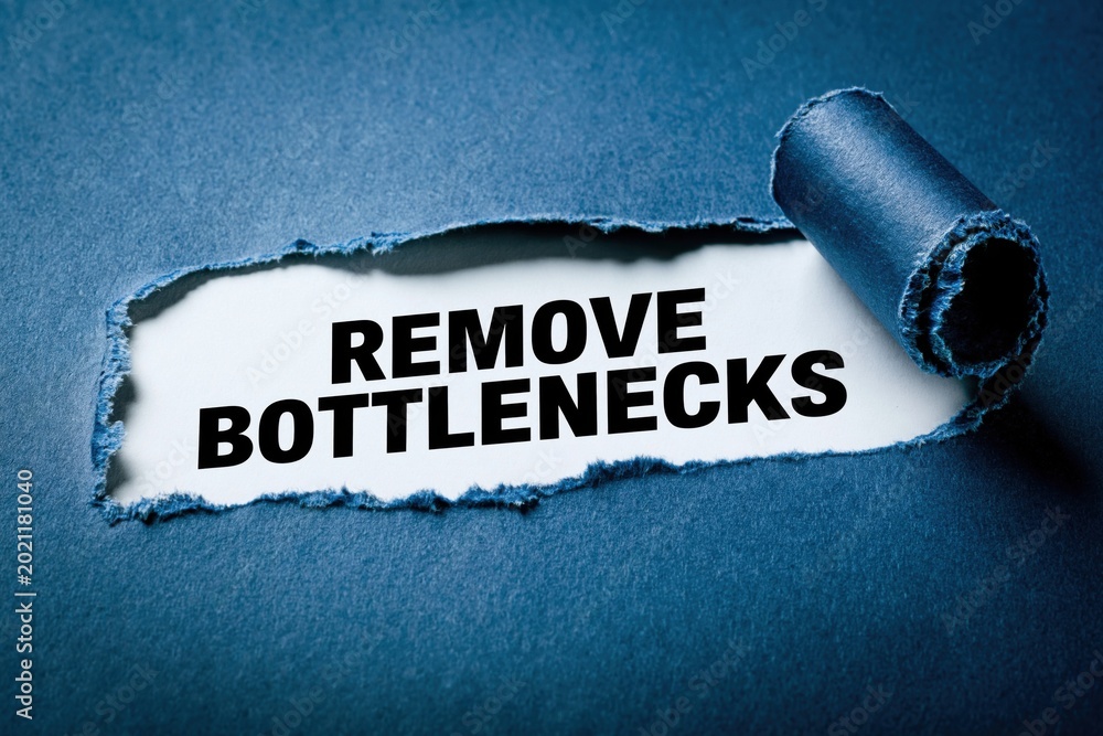 Fototapeta premium Remove Bottlenecks productivity advice on torn paper