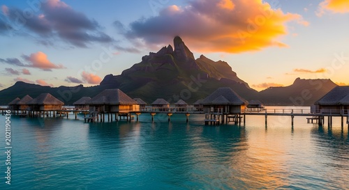Bora bora overwater bungalows at sunset with mount otemanu in the background, french polynesia