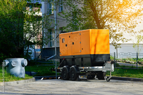 Photography Mobile diesel generator on trailer in city parking lot