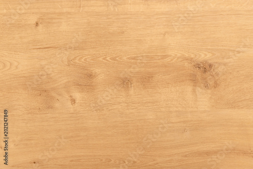 Natural oak wood texture tabletop background with warm wooden surface and sub...