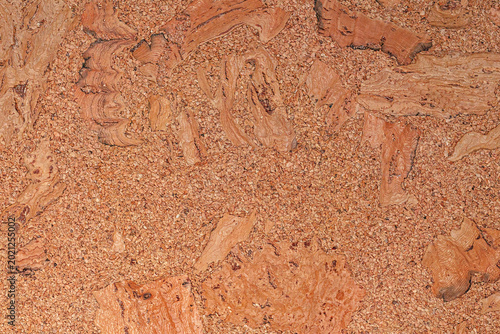 Brown corkboard texture with organic pattern. Close-up of natural granulated cork material background.