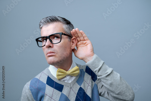 Man listening to a loud noise