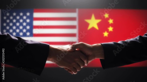 Diplomatic handshake between USA and China representatives with flags