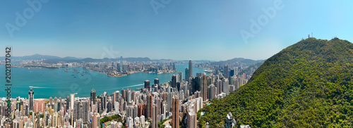 Fotografie Wide panoramic aerial views of the cityscape and forested hills with cliffs and