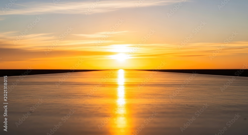 Fototapeta premium A bright golden sunrise illuminates a glowing path leading toward the distant horizon amidst an atmosphere of progress and steady momentum, pathway, excellence, abstract