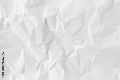 Abstract white crumpled paper texture background. Creased messy paper sheet with shadows and folds for creative minimalist design concept.