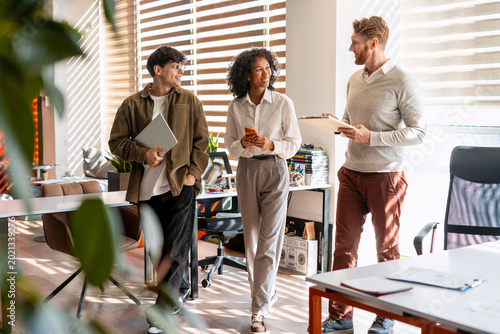 Diverse business team collaborating in shared modern office