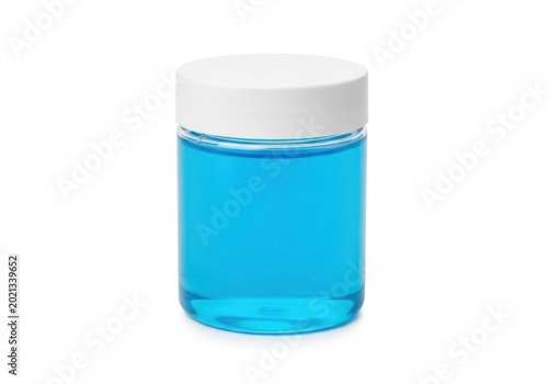 A small jar filled with blue liquid against a white background