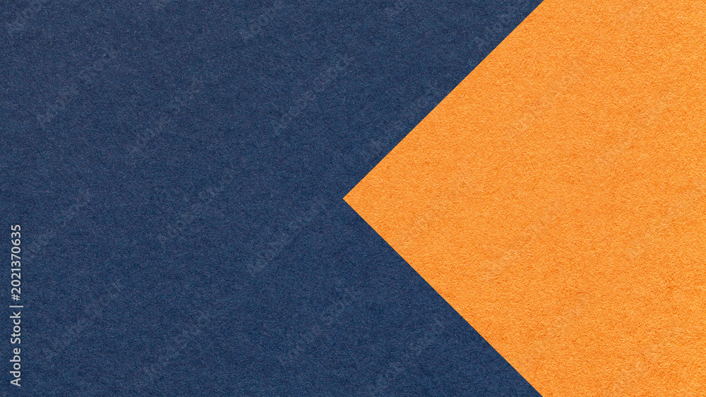 Fototapeta premium Textured dark blue paper background with orange arrow, macro. Template with copy space for banner, presentation