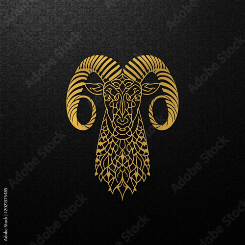 Golden ram head with intricate design on black background