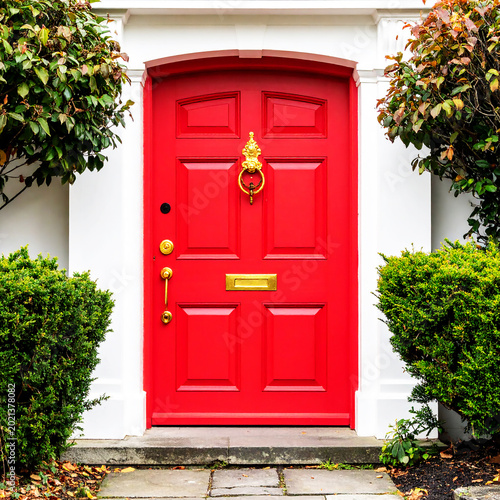 Elegant red door with gold hardware. Classic design and vibrant color make a bold statement. Security features include a peephole on white or transparent background