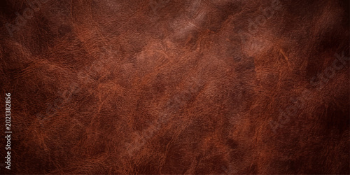 Photos A close-up shot of rich brown leather, showcasing texture and detail, revealing
