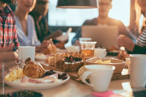 Onboarding breakfast for new employees in a startup office with team engagement