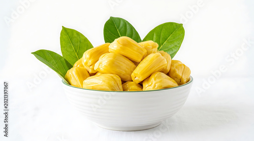 Fresh jackfruit pieces in a white bowl with green leaves on white surface transparent background