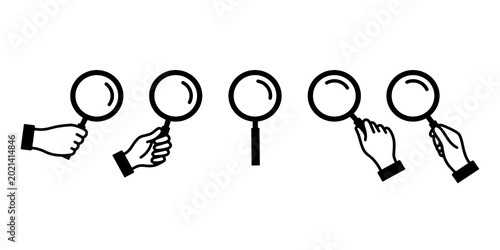 Tableau sur toile Icon of a hand holding a magnifying glass/loupe