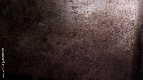 Oxidized baking sheet with charred spots and vintage brown surface. Abstract worn metal backdrop featuring heat damage. Rugged grunge texture