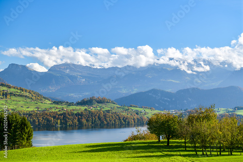 Calm lake with snow-dusted Alps in autumn