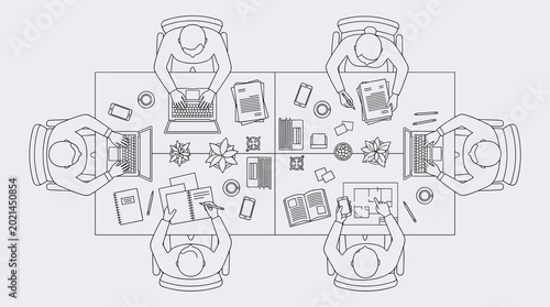 Overhead view of people collaborating around a conference table with laptops and documents in a modern office setting