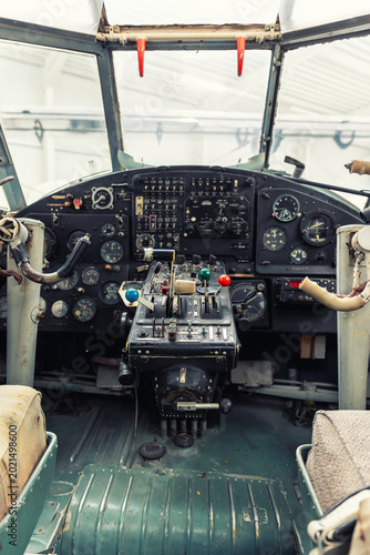 Fotografie Vintage aircraft cockpit interior analog instruments, control levers worn pilot steering handles