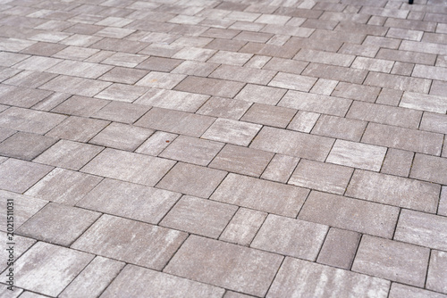 Textured gray pavers arranged in a geometric pattern, ideal for landscaping and outdoor design projects, providing a modern and durable surface