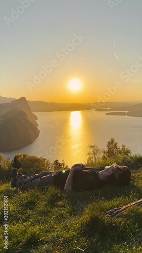 Young Man Relaxing on Mountain Meadow at Sunset Over Lake Lucerne, Märibänkli Viewpoint Above Vitznau, Rigi, Switzerland