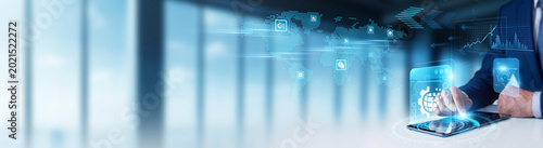 Fotografie Businessman using digital tablet to monitor Digital Transformation and global corporate modernization data technology integration, legacy system updates, and digital business modeling