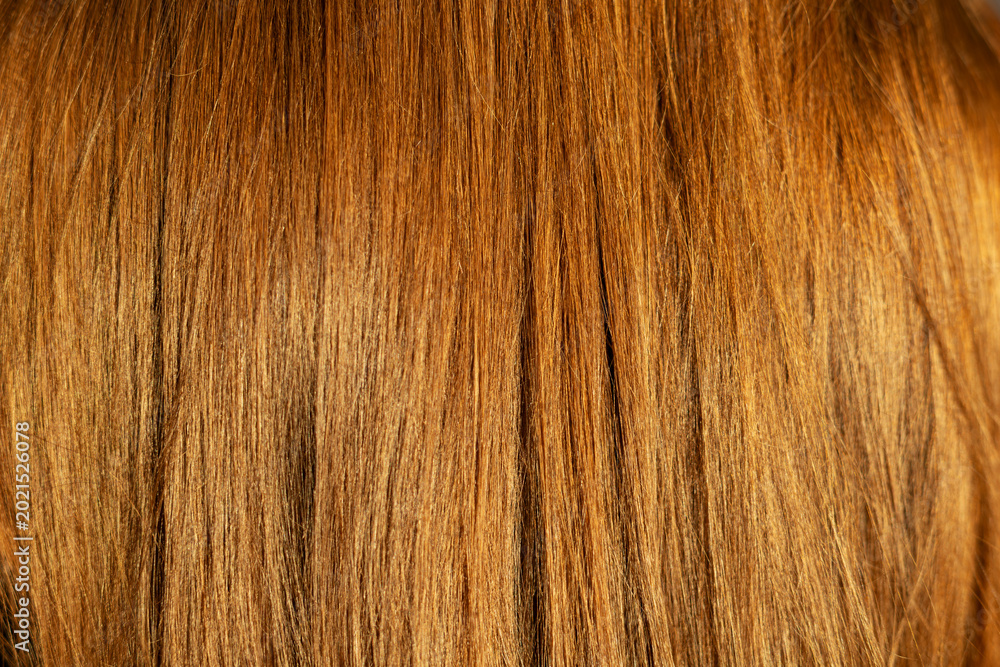 Naklejka premium Close-Up Texture of Shiny Red Hair. Detailed close-up of smooth red hair strands showing natural shine, warm color, texture, and healthy hair care beauty.