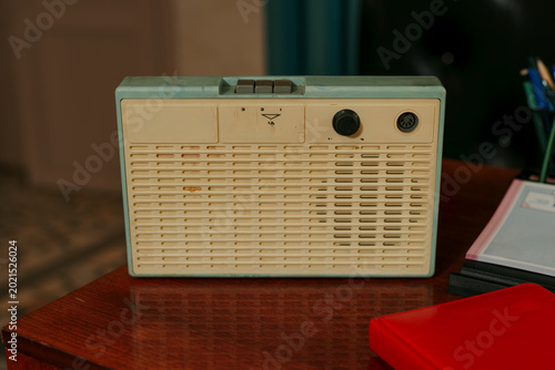 Vintage Soviet three program wired radio speaker on wooden desk.j