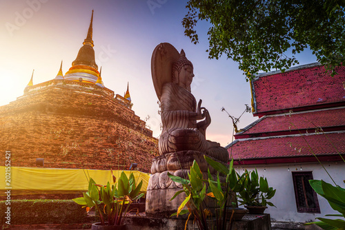 Obraz na płótnie Buddha statue and Phra Chedi Luang in Temple (Thai language:Wat Ratchaburana) is a Buddhist temple It is a major tourist attraction in Phitsanulok, Thailand