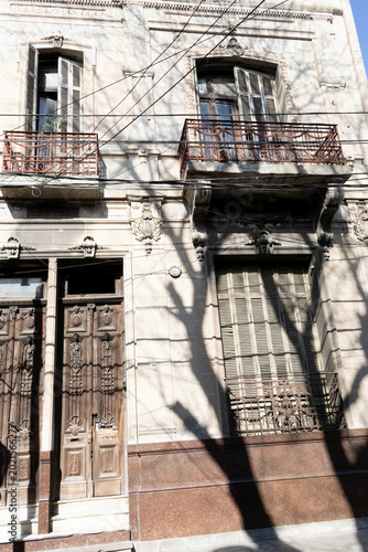 Bright daylight illuminates an ornate, historic building facade. 