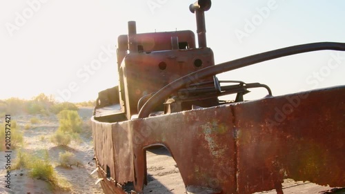 Moynaq Ship Graveyard Uzbekistan sunrise. Rusted fishing vessels stranded in the Aralkum Desert. Environmental disaster memorial showing the dried Aral Sea and lost maritime heritage in Muynak.