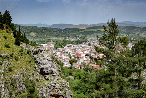 View at the Livadia city at Boeotia-Greece from the top of a mountain. Green fields blue sky and mountains at the background