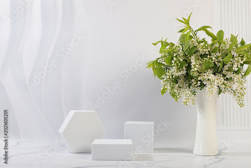 Abstract floral arrangement with bird cherry. Aesthetically pleasing cosmetic display case with floral decor for showcasing beauty products. Minimalistic, modern design.