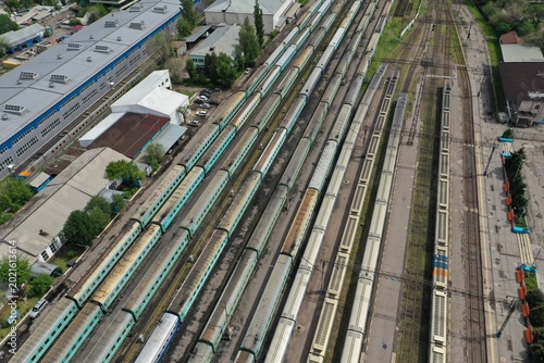 Obraz na plátne Aerial View of Multiple Passenger Trains Stationed on Parallel Railway Tracks