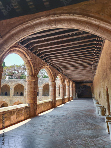 Medieval vaulted stone corridor and courtyard of the Archaeological Museum in Rhodes Greece