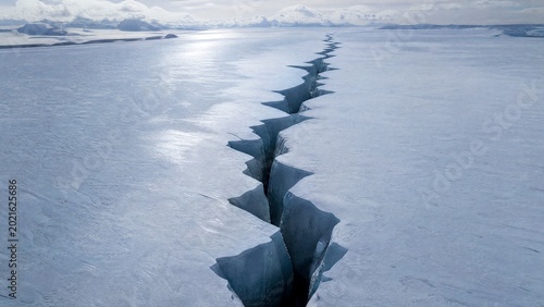 uriel. Aerial view of a deep lightning-shaped crack splitting a smooth glacier surface. travel magazines, destination branding, designed for travel destination branding, used by lab technicians.
