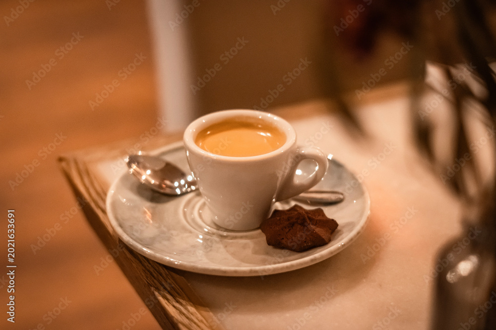 Fototapeta premium Espresso Coffee Cup on Elegant Restaurant Table with Warm Ambient Lighting and Copy Space
