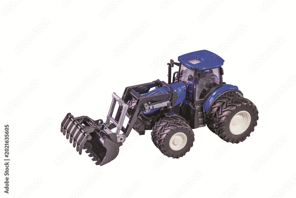 Naklejka premium Close-up view of blue remote control toy tractor with front loader isolated on white background. Sweden.