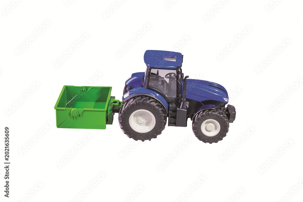 Obraz premium Close-up view of blue remote control toy tractor with trailer isolated on white background. Sweden.