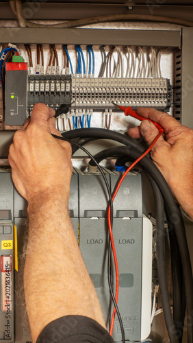 Photos Specialist electrical commissioning engineer investigating a fault on an automatic transfer switch