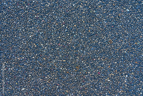 Tokyo, Japan - Oct 1 2024, Close-up view of the road surface consisting of small stones, pebbles, gravel, at daytime, Tokyo, Japan