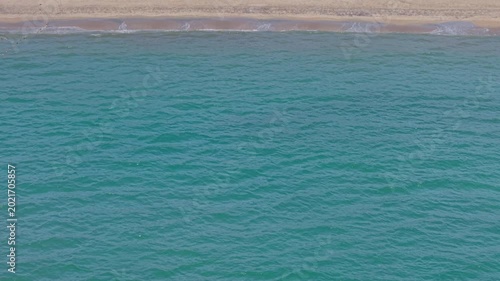 Summer seascape beautiful waves, blue sea water in sunny day. Royalty high-quality free best stock of tranquil beach with turquoise waves splashing, sand shore. Aerial view, tropical nature background