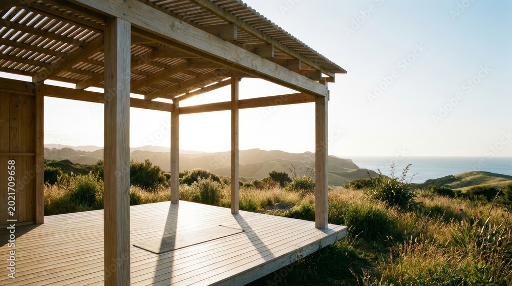 Fototapeta premium Open air pavilion overlooking coastal landscape at sunset with outdoor space